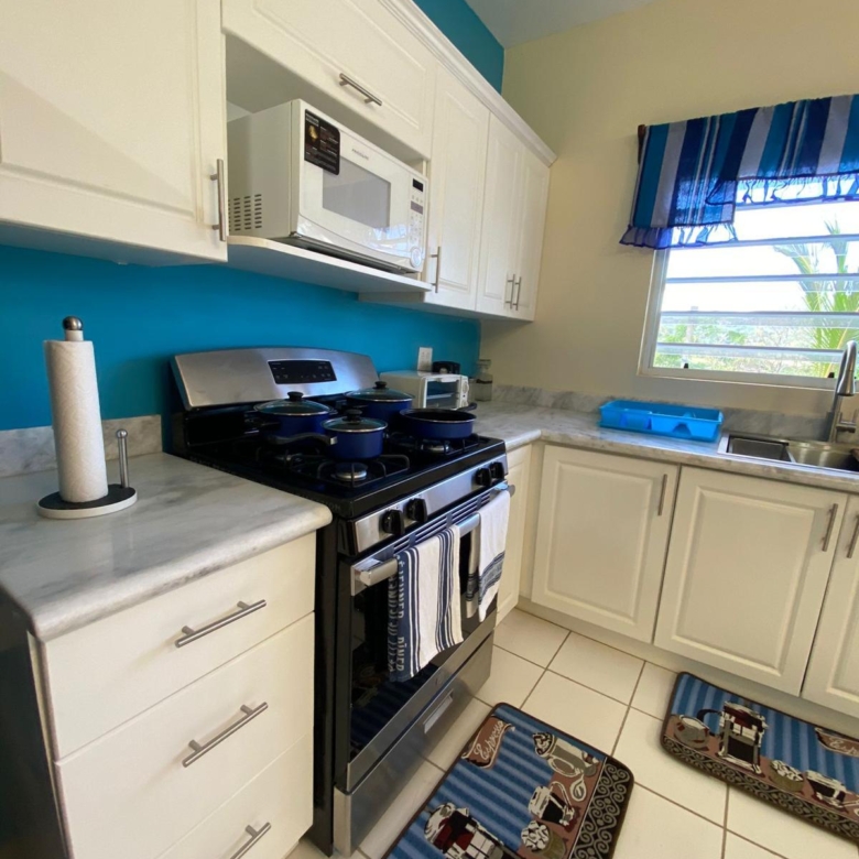 Gas stove, microwave and marble worktops in the kitchen of a furnished 1 bedroom apartment, Crescent Hill, Basseterre