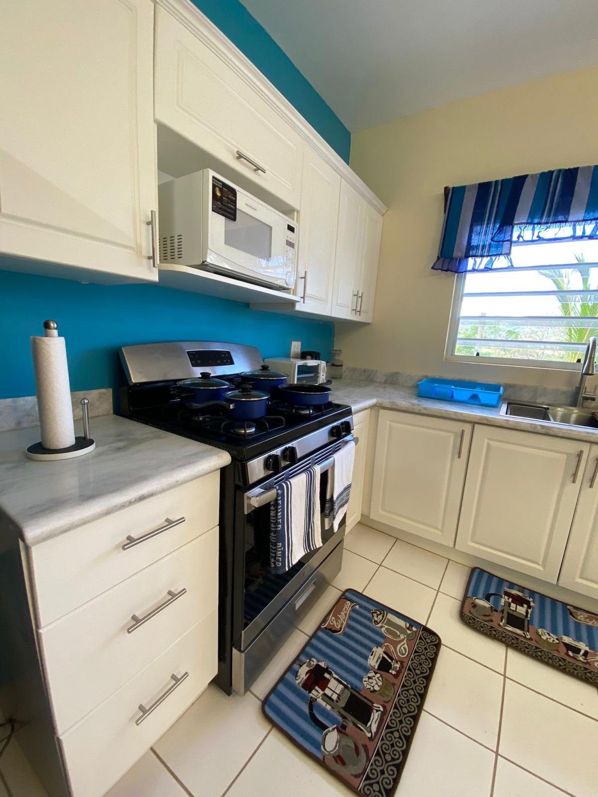 Kitchen with gas stove Gas stove, microwave and marble worktops in the kitchen of a furnished 1 bedroom apartment, Crescent Hill, Basseterre
