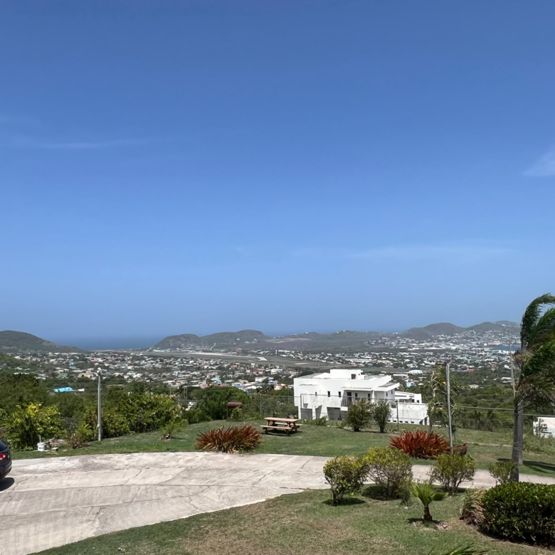 View over Basseterre and the sea from the grounds of a furnished 1 bedroom rental at Crescent Hill, St. Kitts