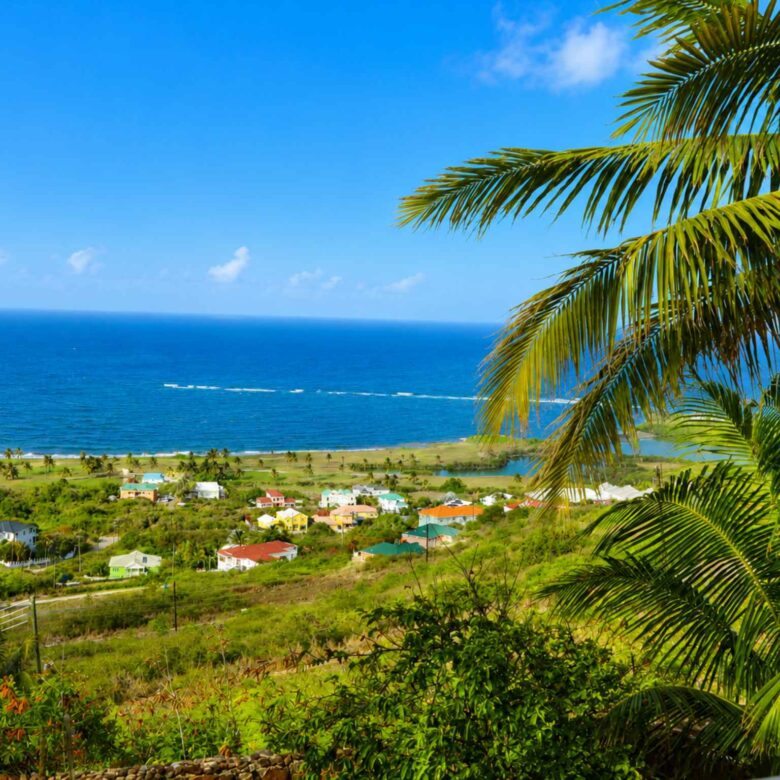 Unobstructed Atlantic Ocean view over green hillside and coastal village, seen from the property