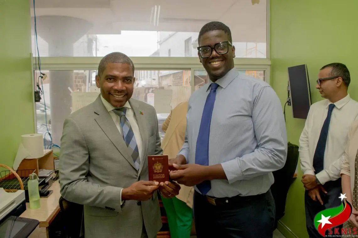 Prime Minister Dr Terrence Drew holding new St Kitts and Nevis Passport
