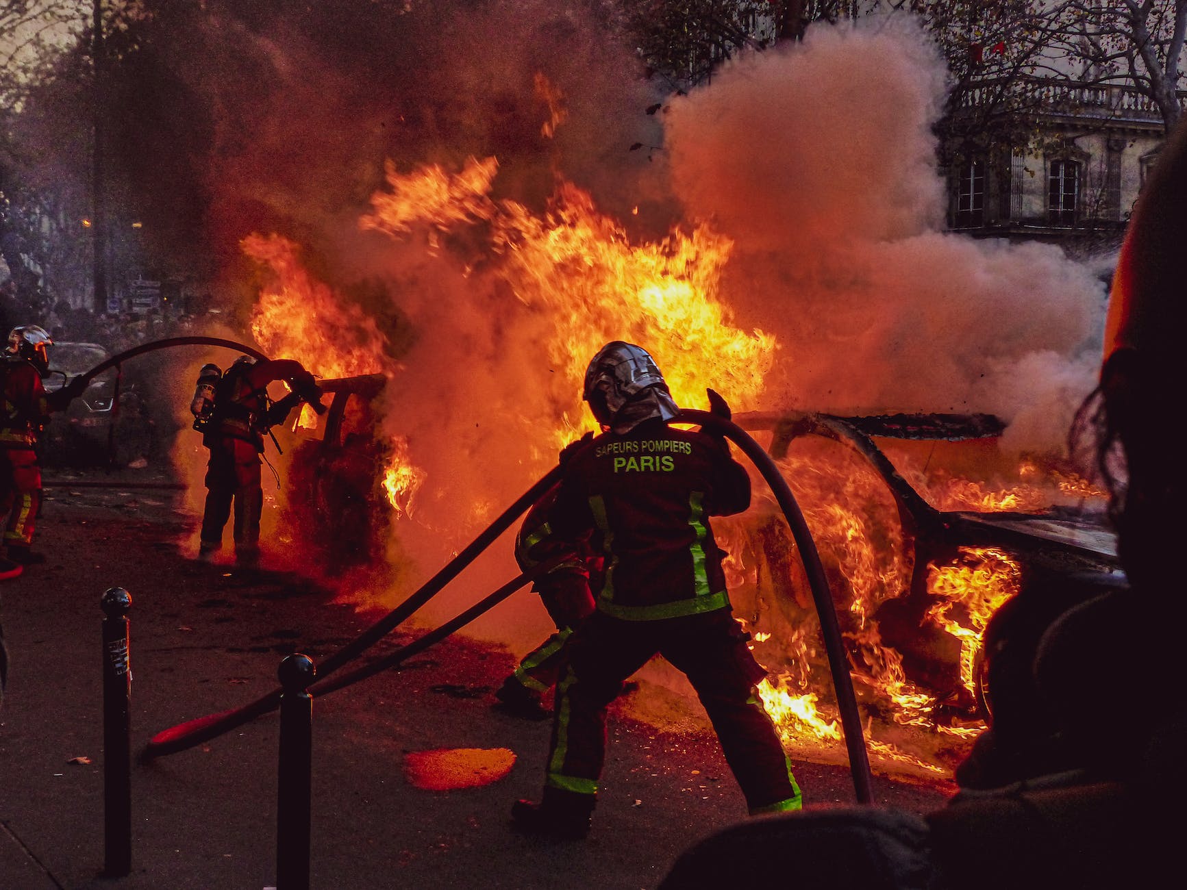 firemen extinguishing a blazing car fire