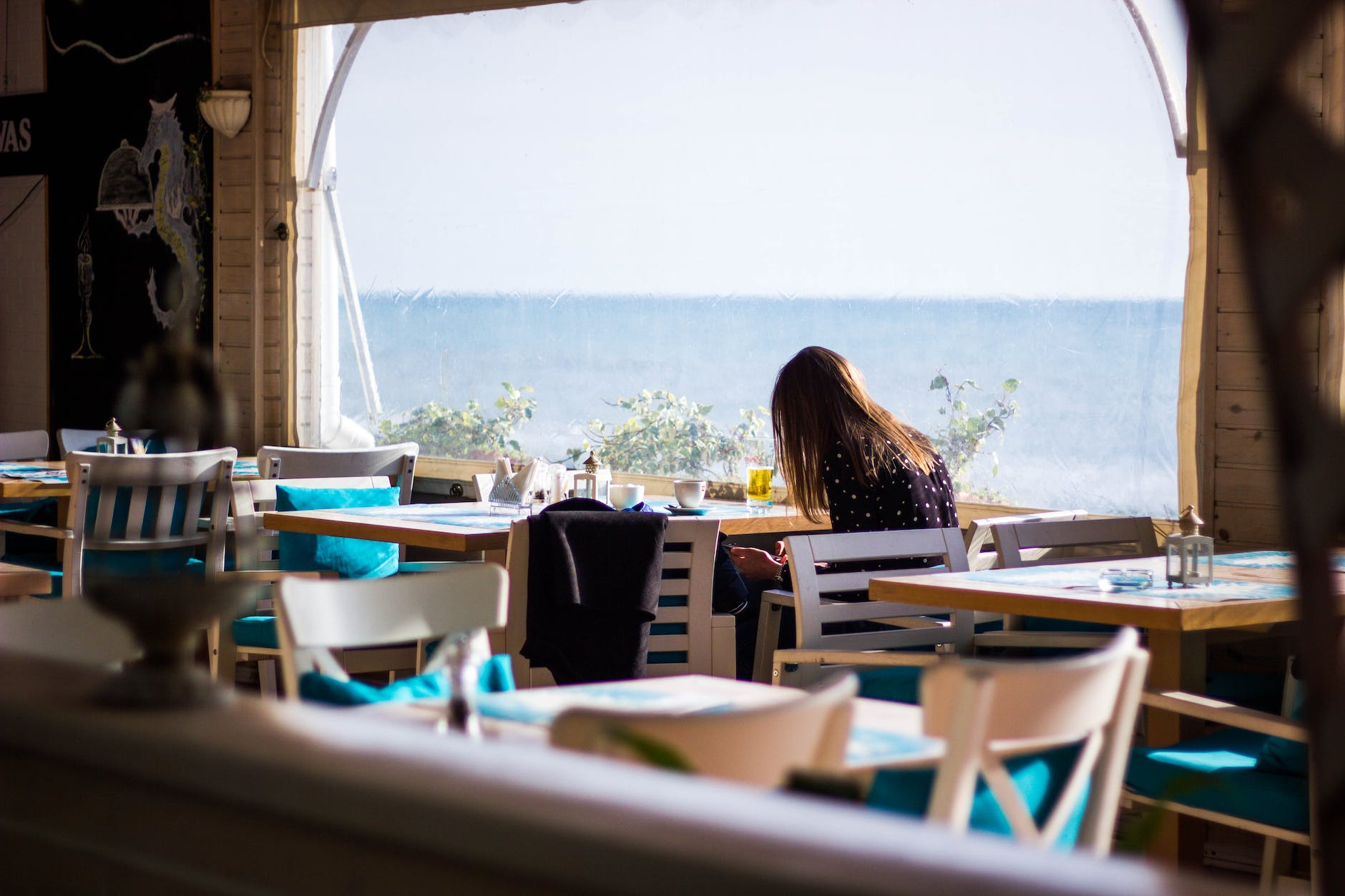 woman sitting on chair with view of sea